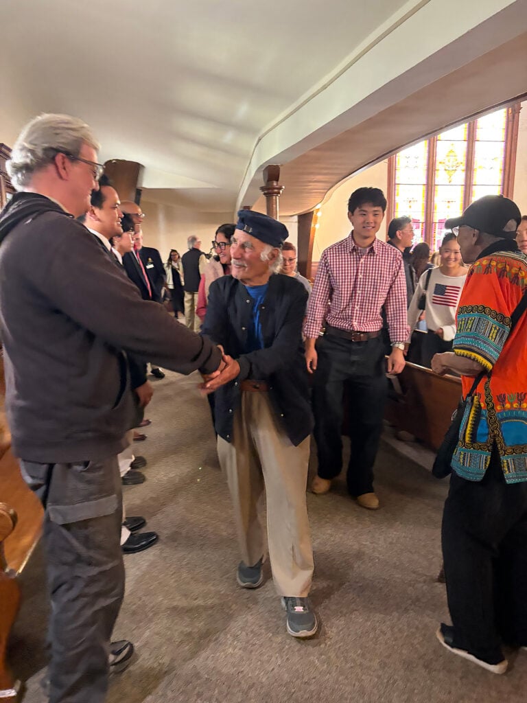 Photo of church members from different congregations mingling after the service