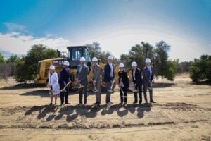 Group of people with shovels break ground on a new hospital facility in Loma Linda, California