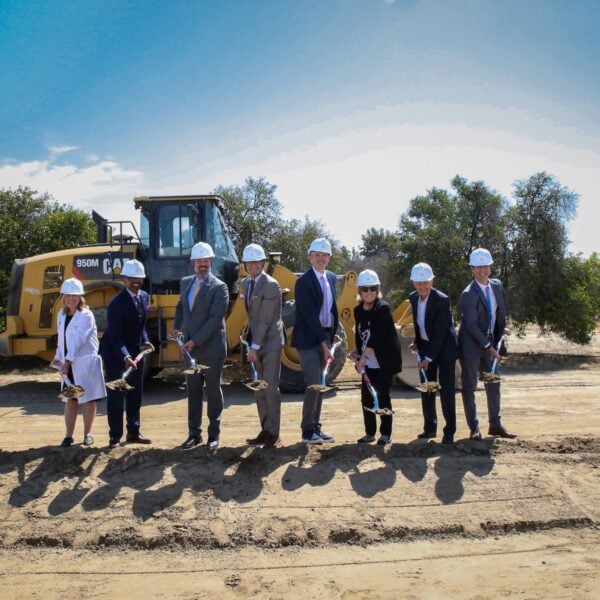 Group of people with shovels break ground on a new hospital facility in Loma Linda, California