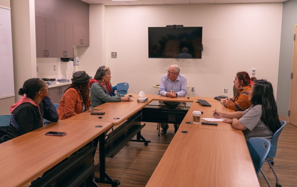 NAD and Alaska Conference reps sit around a table with behavioral health professionals in Bethel, Alaska