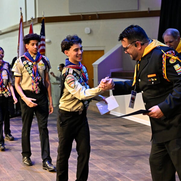 Armando Miranda Jr. and other leaders give Pathfinders their certificates at the end of PBE.