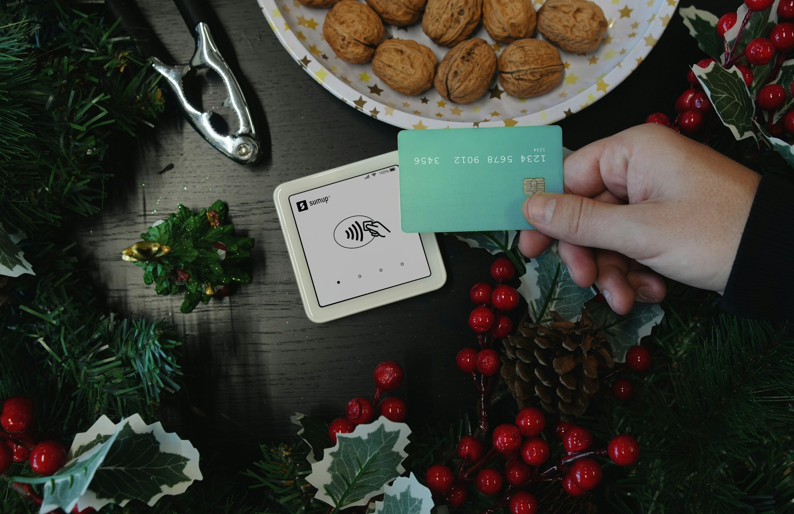 A person holding a card next to a plate of cookies