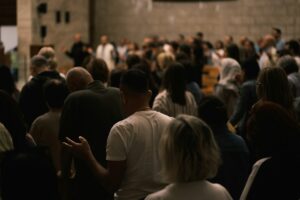 A congregation gathered inside a large hall.