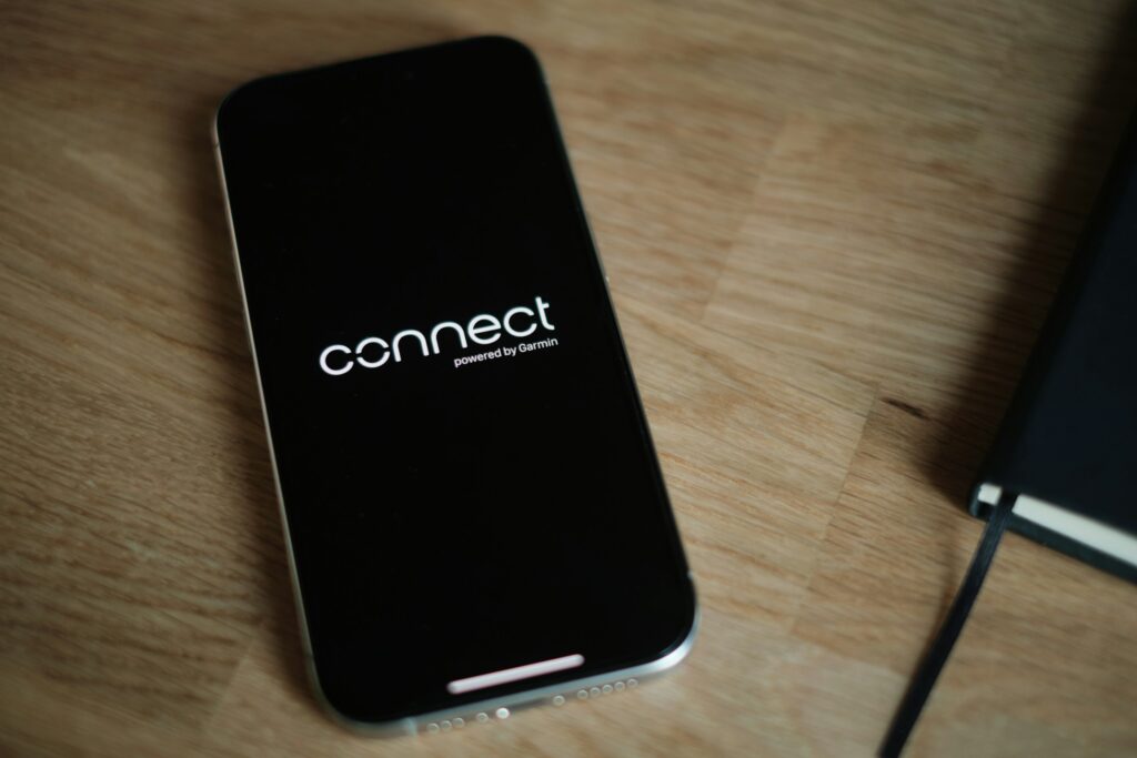 A cell phone sitting on top of a wooden table