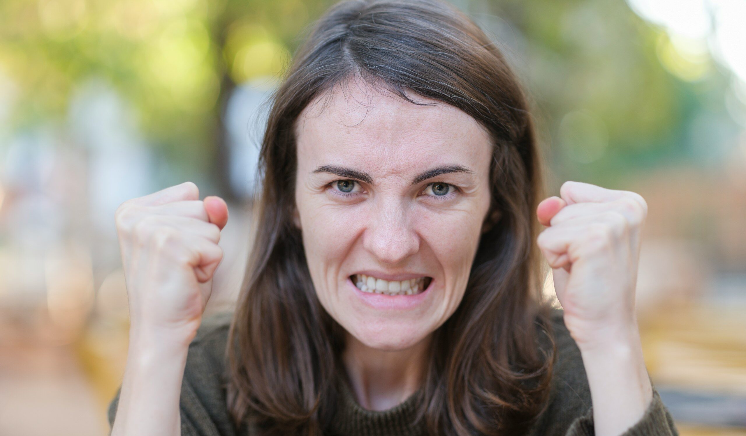 a woman holding her fists up in the air