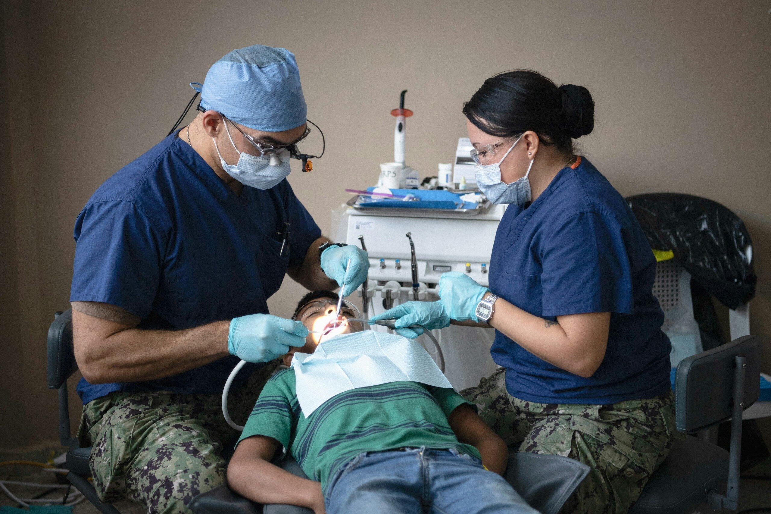 Dentists providing dental care to a patient