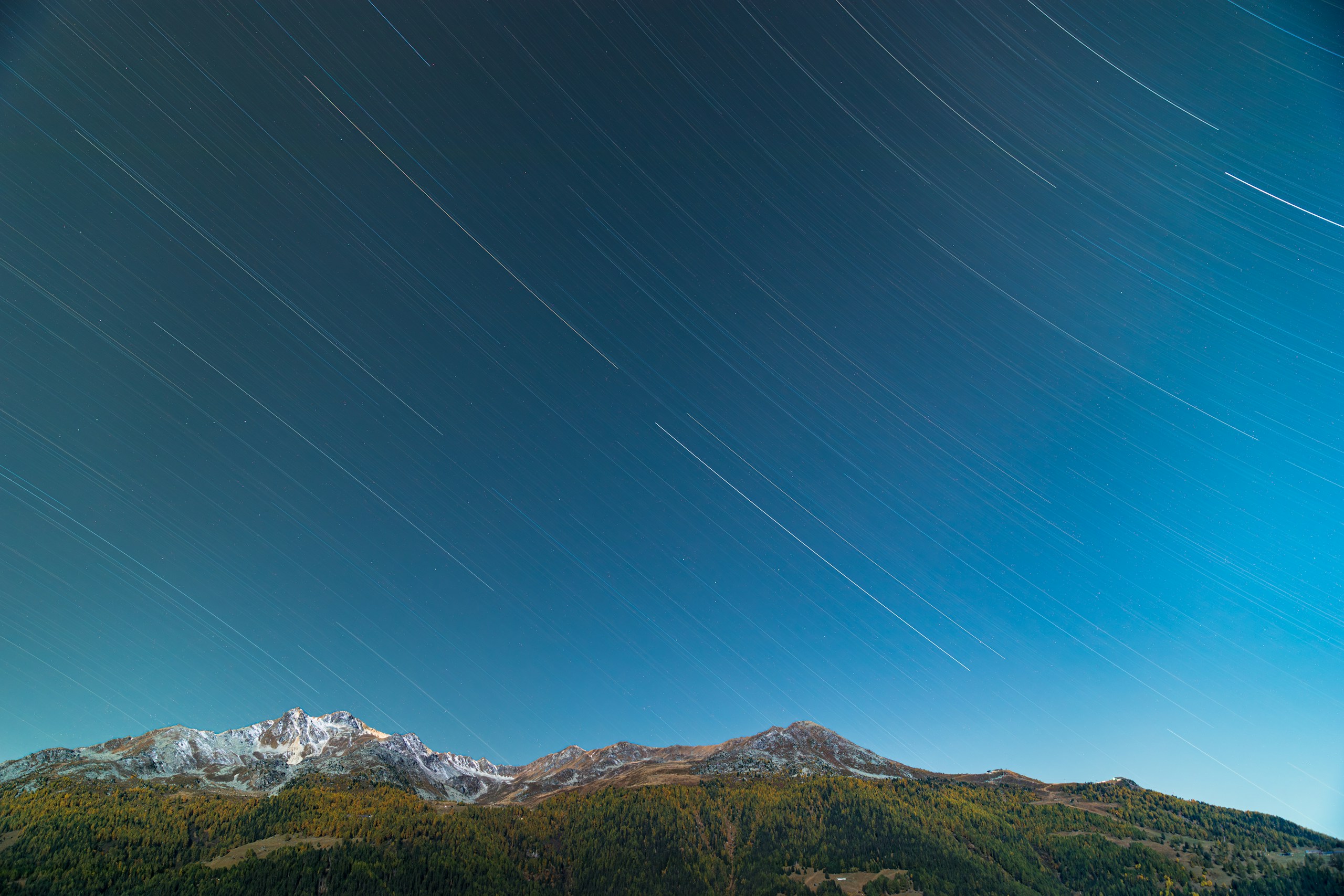 Star trails over mountains at night