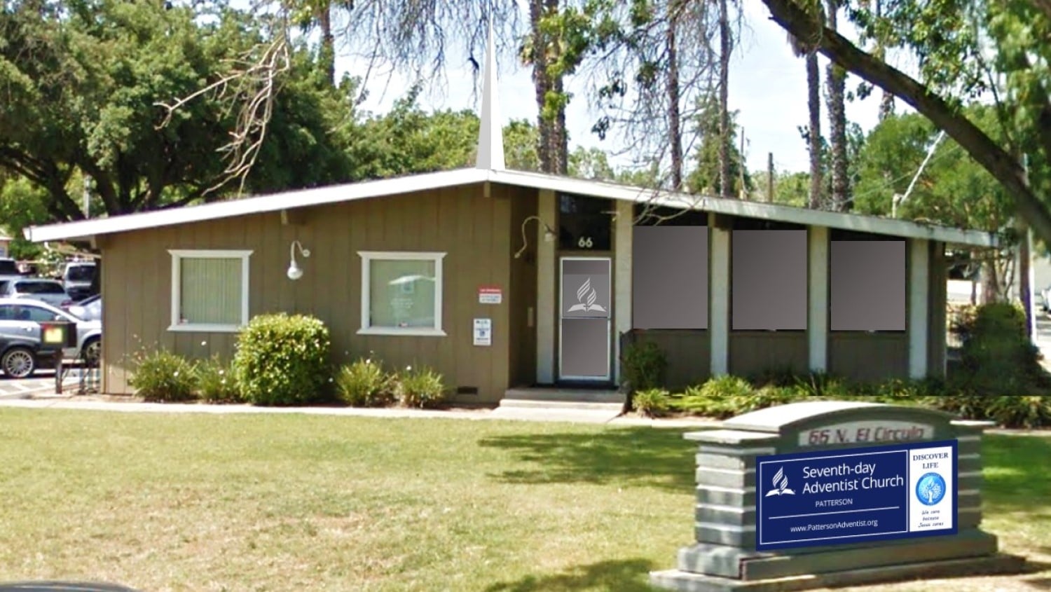 A picture of the front of the church building with the sign.