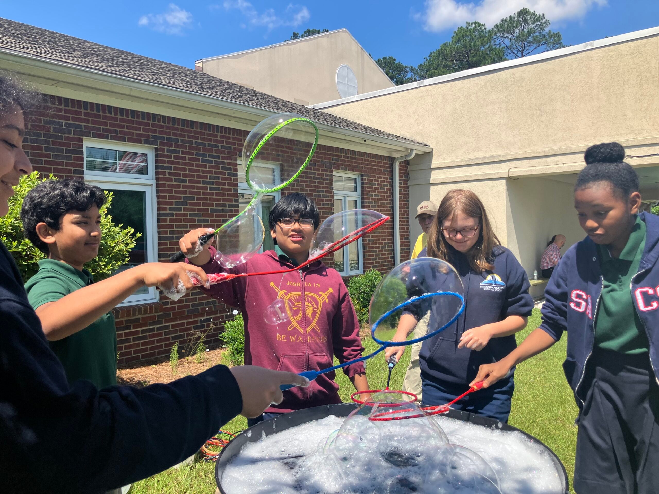 Students playing with bubbles outdoors