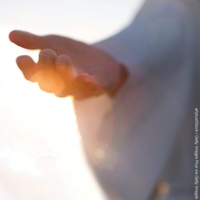 Jesus Christ with open arms reaching out in the sky, hand gestures of Jesus dying on the cross and resurrected, heaven and salvation, faith and love, easter concept