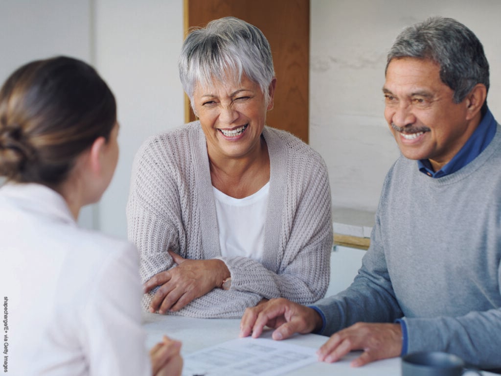 Shot of a senior couple meeting with a consultant to discuss paperwork at home