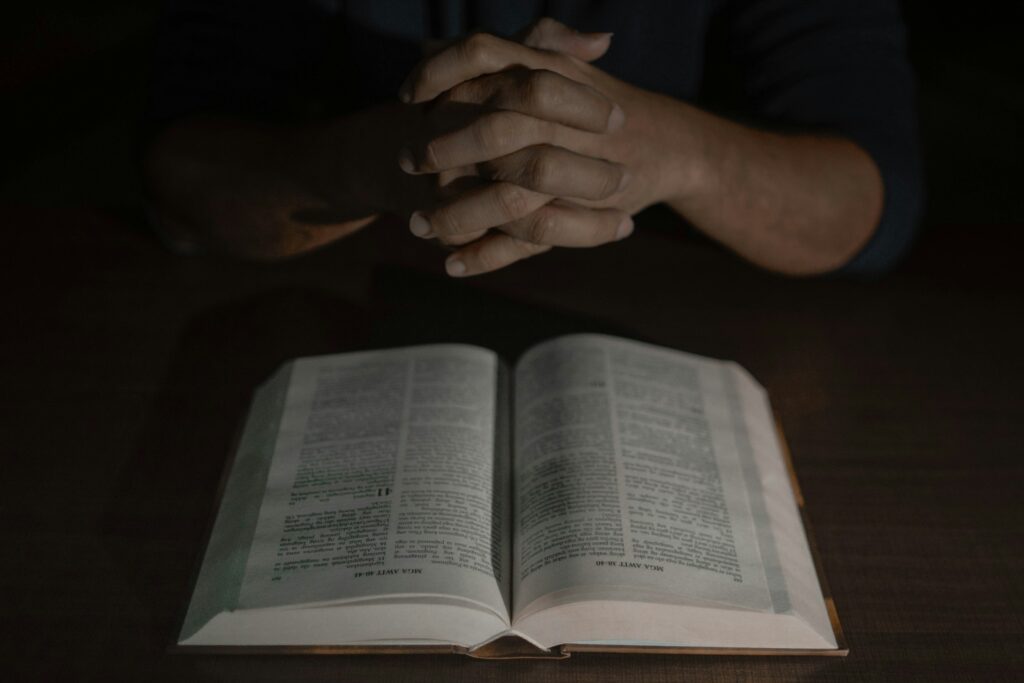 a person holding their hands over an open book
