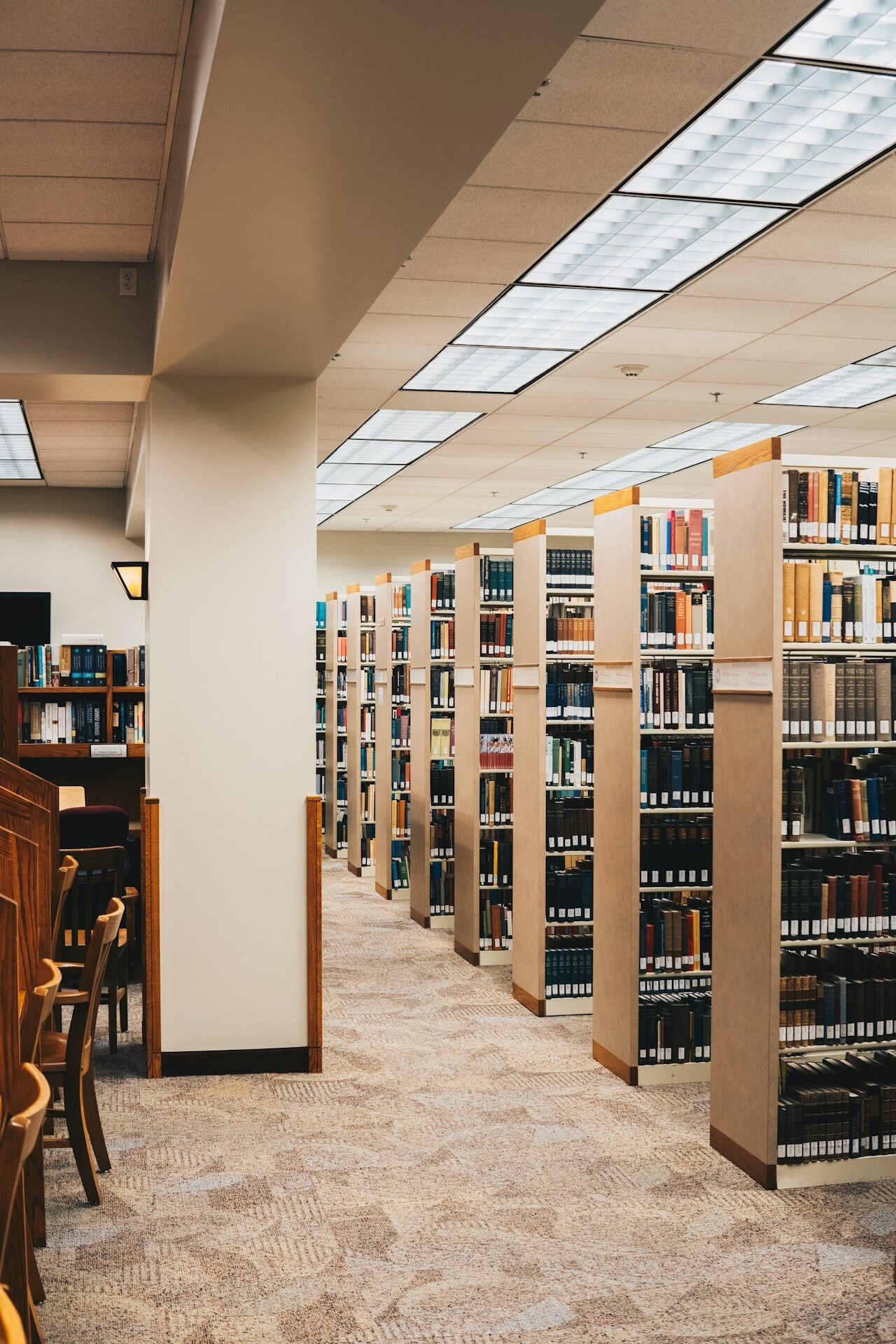 A library filled with lots of books and chairs
