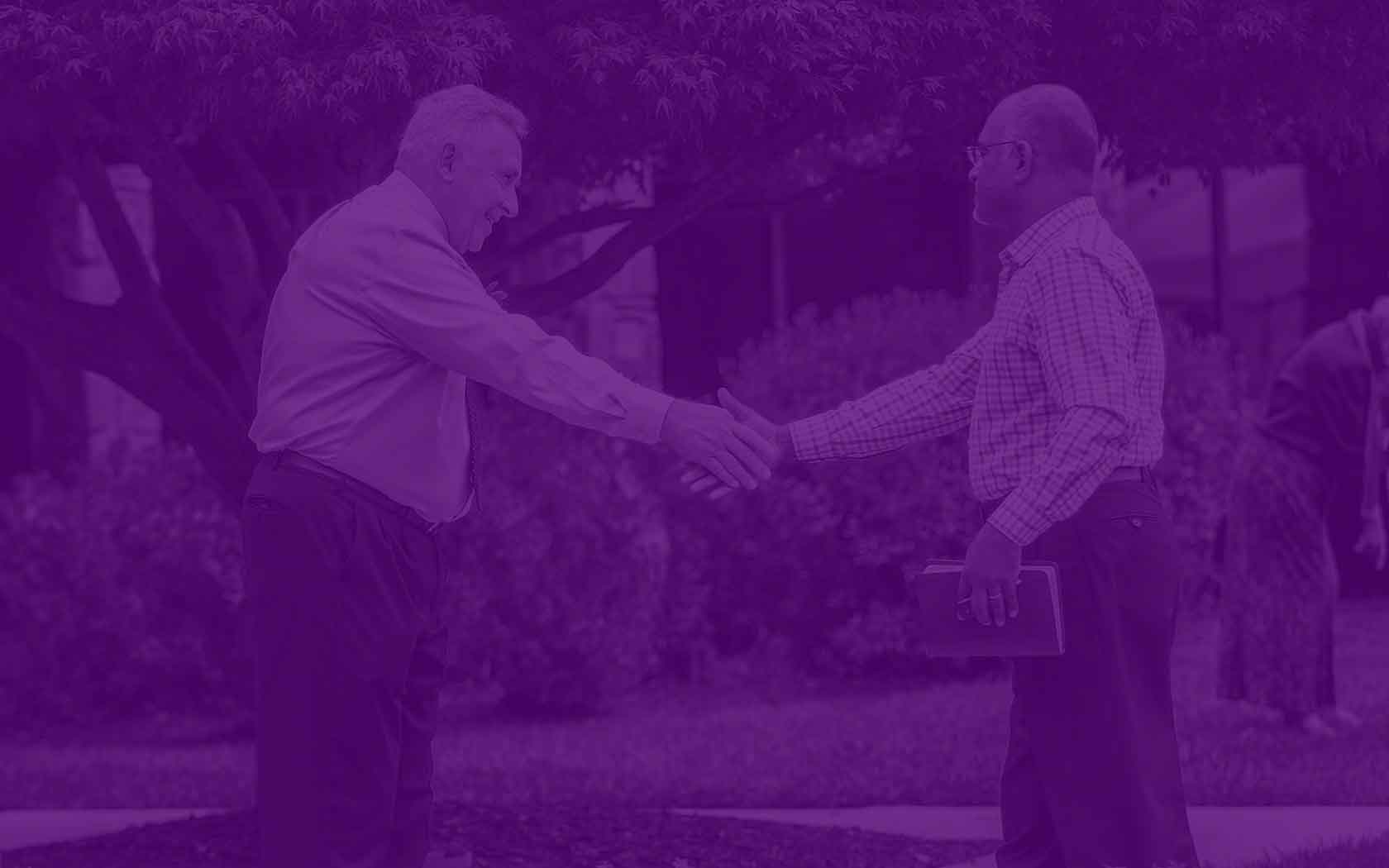 two men shaking hands outside of Spencerville Church in Silver Spring, Maryland