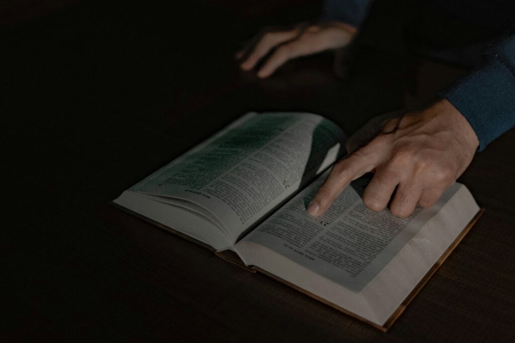 a person touching a book with their hand