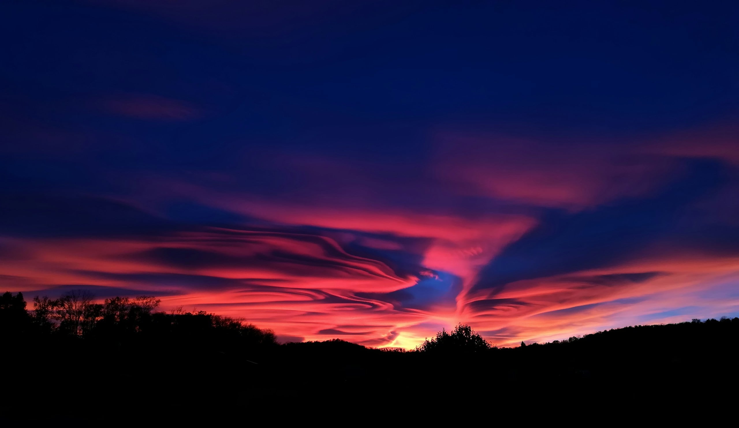 silhouette photo of mountain highlighting Jesus' Seconf Coming will be in the clouds