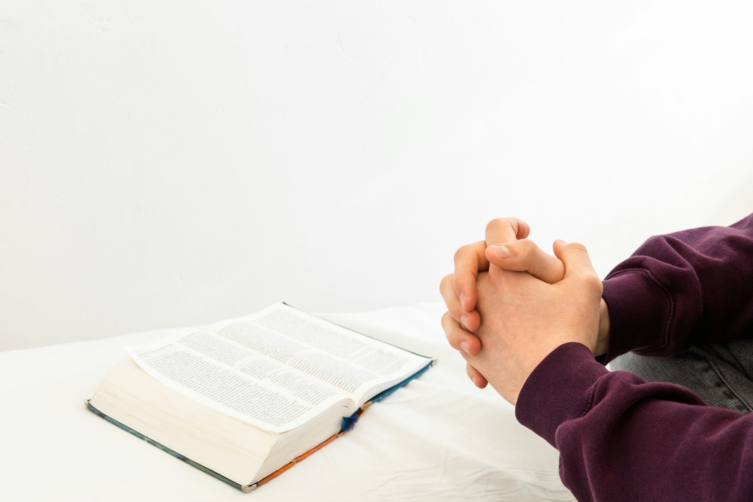 a person sitting at a table with an open book