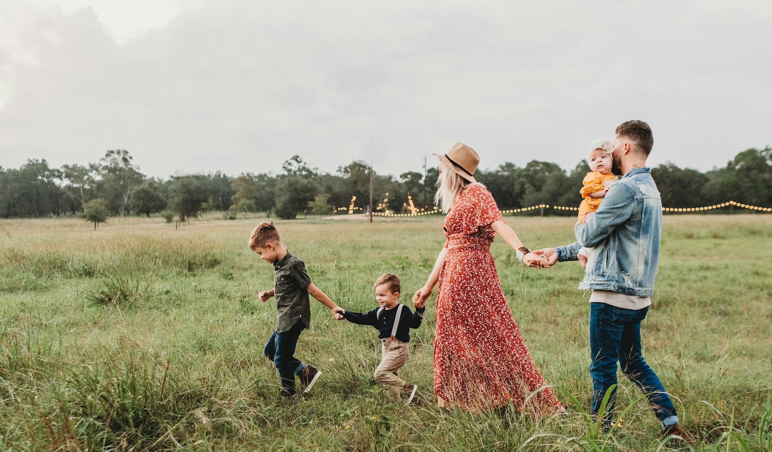woman holding man and toddler hands during daytime