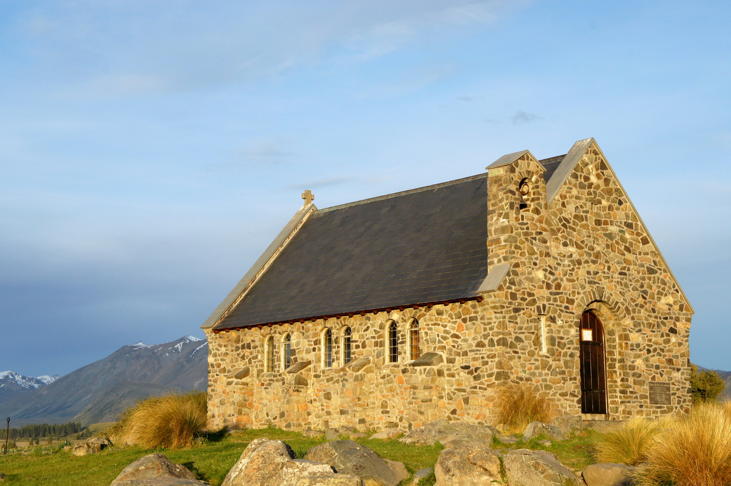 a stone building with a cross on top