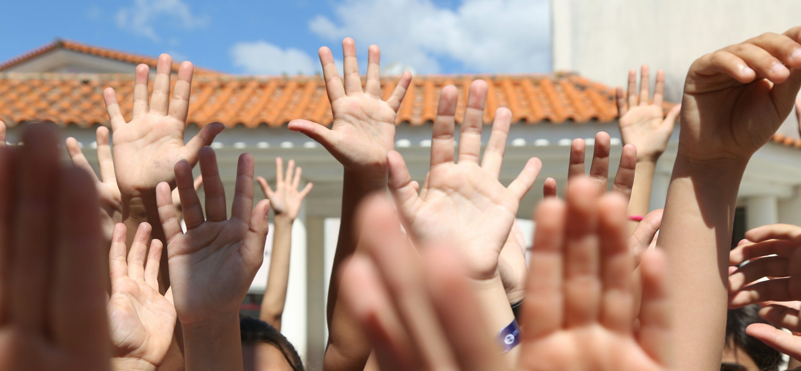 a group of people raising their hands in the air