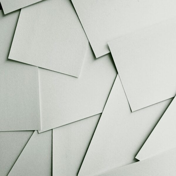 Scattered sheets of white paper covering the entire frame