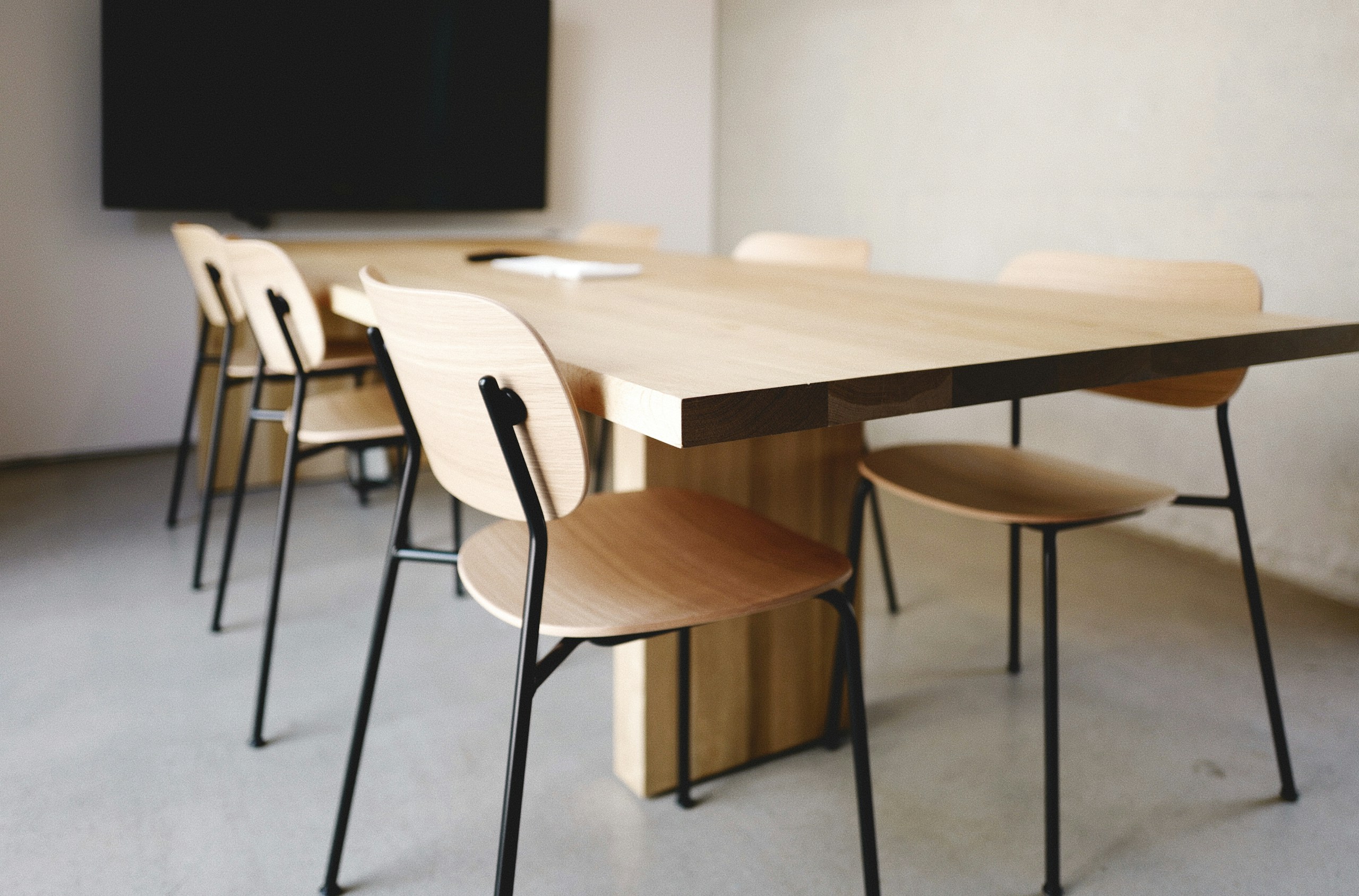 a wooden table with four chairs around it
