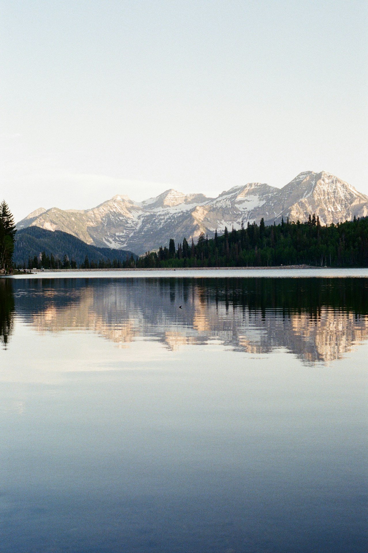 Mountains reflect beautifully in the still lake water.